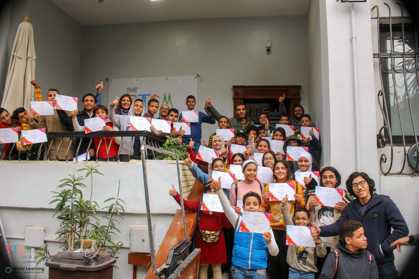 A cohort of students holding their certificates.